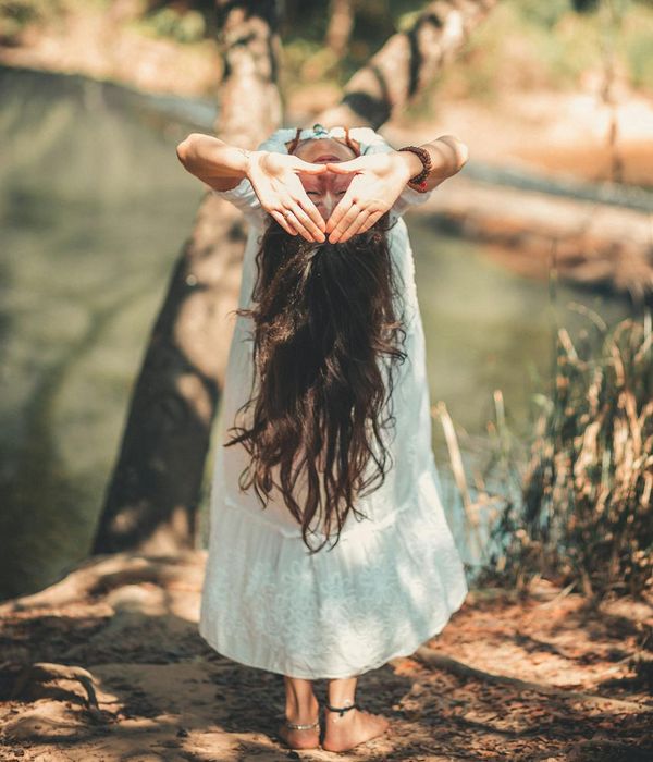 Woman holding a serene yoga pose in a calm environment.